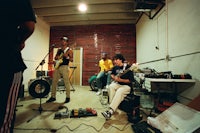 a group of people playing music in a room